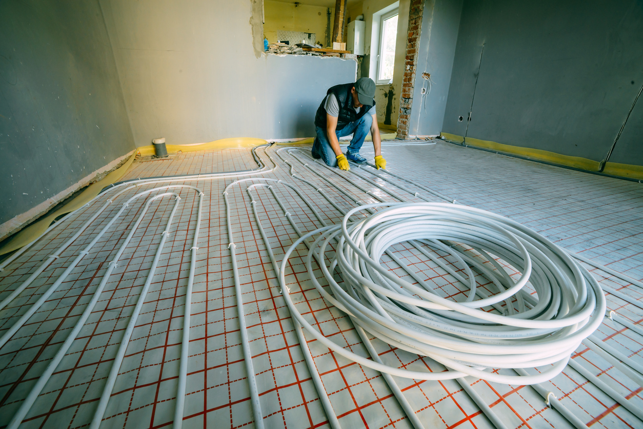 workers installing geothermal floor heating